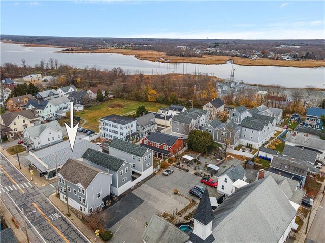 drone / aerial view with a residential view and a water view