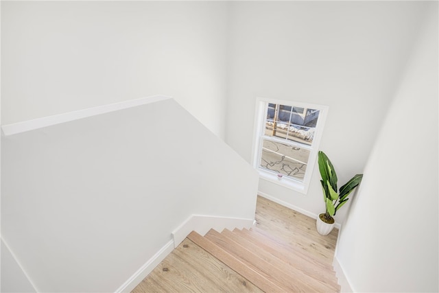 stairs with baseboards and wood finished floors