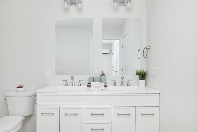 full bathroom featuring a sink, toilet, and double vanity