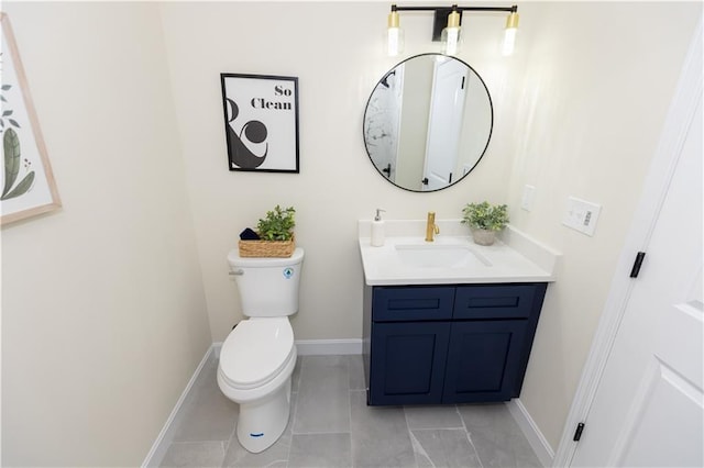 bathroom featuring vanity, tile patterned floors, and toilet