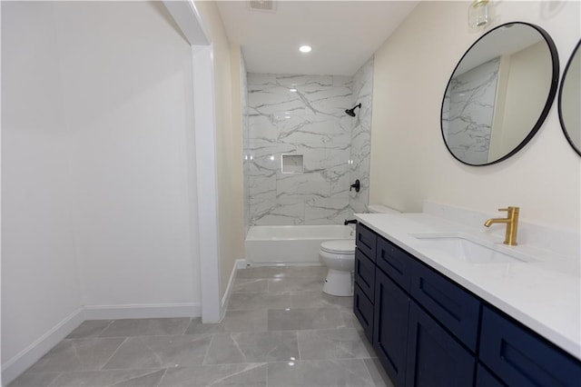 full bathroom featuring vanity, toilet, and tiled shower / bath