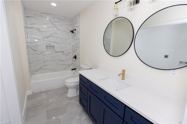 full bathroom featuring tiled shower / bath, vanity, and toilet