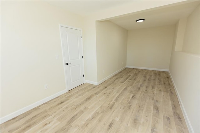 empty room with light hardwood / wood-style flooring