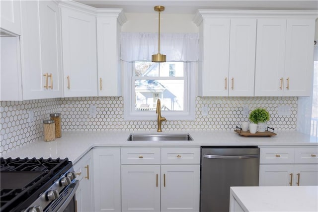 kitchen featuring sink, white cabinetry, hanging light fixtures, stainless steel appliances, and backsplash