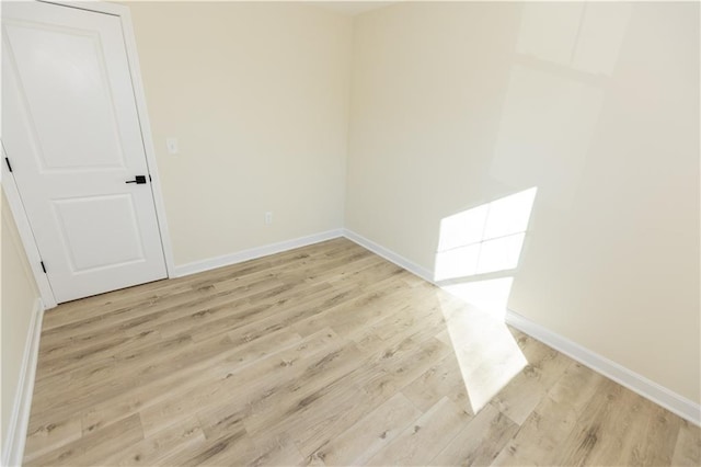 spare room with light hardwood / wood-style flooring