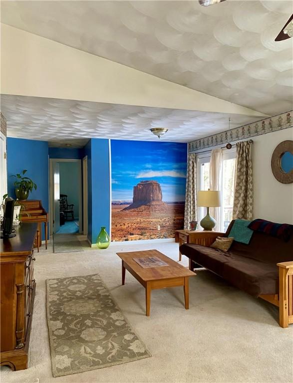 carpeted living room with vaulted ceiling