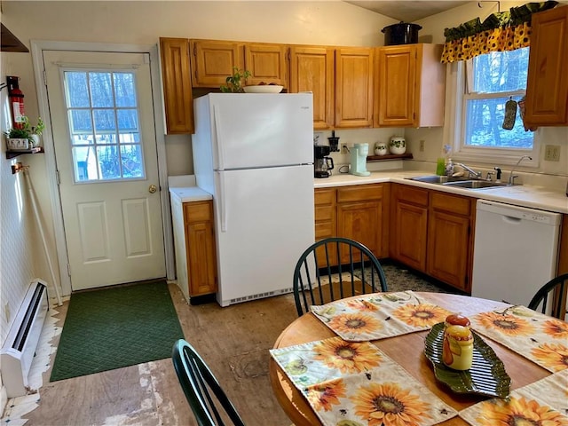 kitchen with sink, white appliances, and baseboard heating