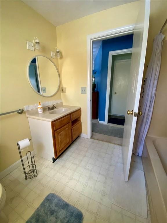 full bathroom featuring toilet, vanity, and shower / bathtub combination with curtain