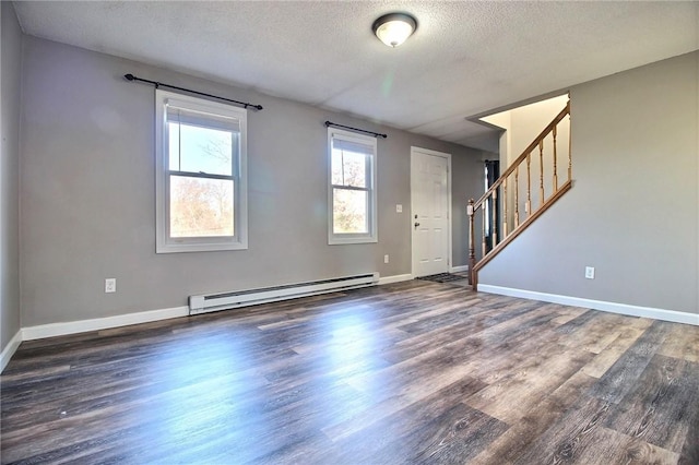 interior space featuring a baseboard heating unit, a textured ceiling, and dark hardwood / wood-style floors