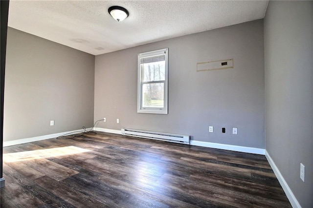 unfurnished room with dark wood-type flooring, a textured ceiling, and a baseboard heating unit