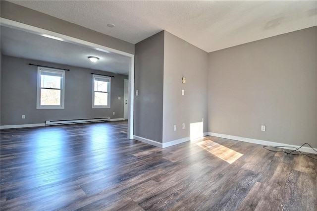 unfurnished room featuring a baseboard radiator, dark hardwood / wood-style floors, and a textured ceiling