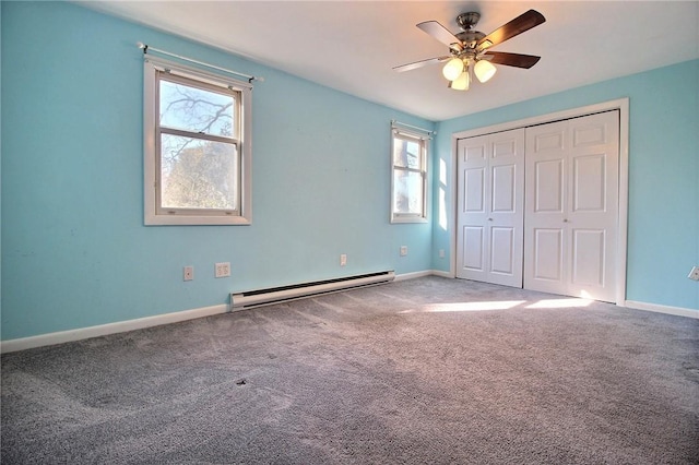 unfurnished bedroom with carpet, a baseboard heating unit, ceiling fan, and a closet