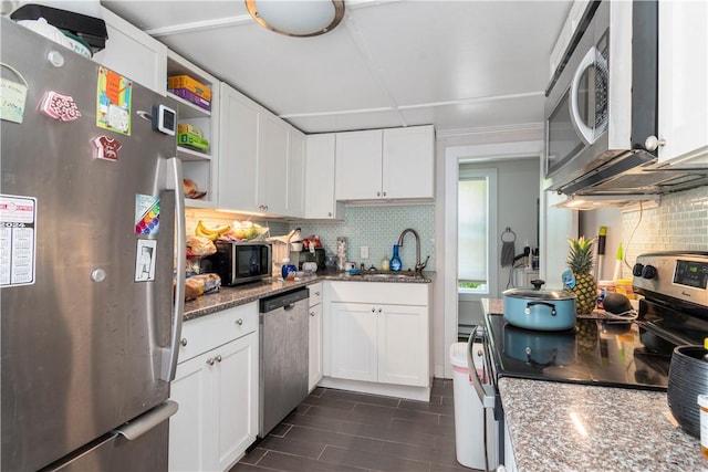 kitchen with stainless steel appliances, sink, and white cabinets