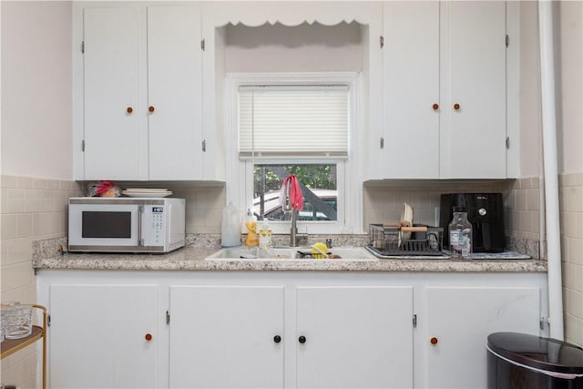 kitchen with white cabinetry and sink