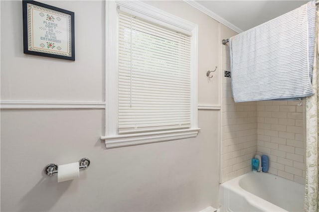 bathroom featuring ornamental molding and bathing tub / shower combination