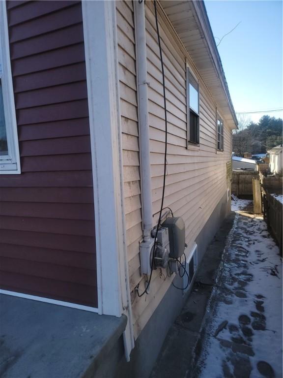 view of side of property featuring fence