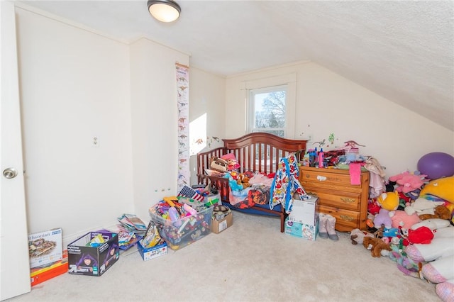 bedroom featuring lofted ceiling, carpet floors, and a textured ceiling