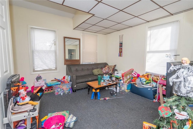 game room with carpet floors and a drop ceiling