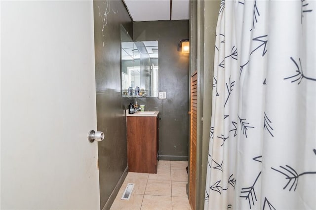 bathroom with tile patterned floors and water heater