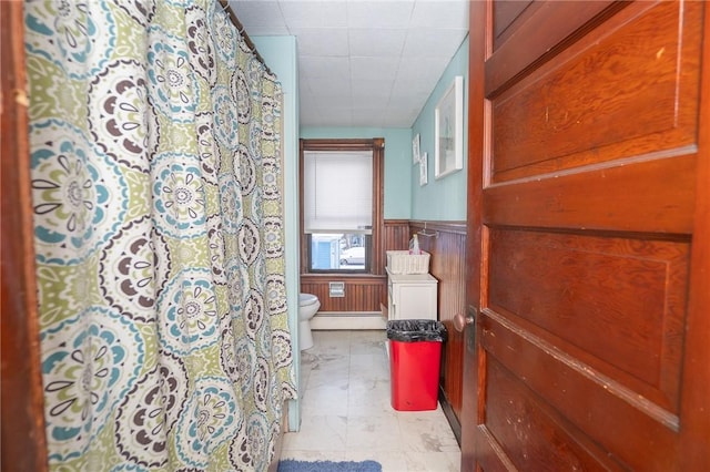 bathroom featuring a baseboard radiator and toilet