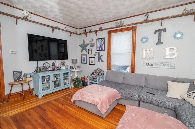 living room featuring ornamental molding and hardwood / wood-style floors