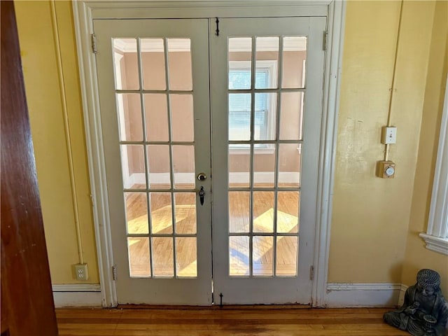 entryway featuring hardwood / wood-style floors and french doors