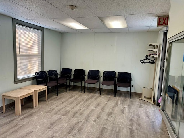 misc room featuring a paneled ceiling and light hardwood / wood-style flooring