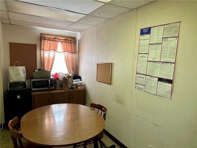 dining room with a drop ceiling