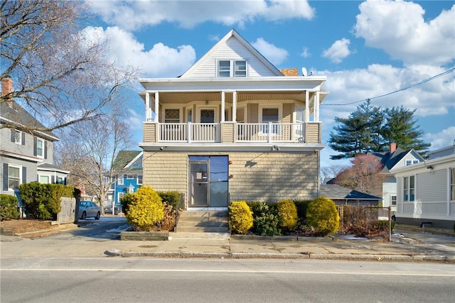 view of front of house featuring a balcony