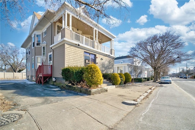 view of side of property with a balcony