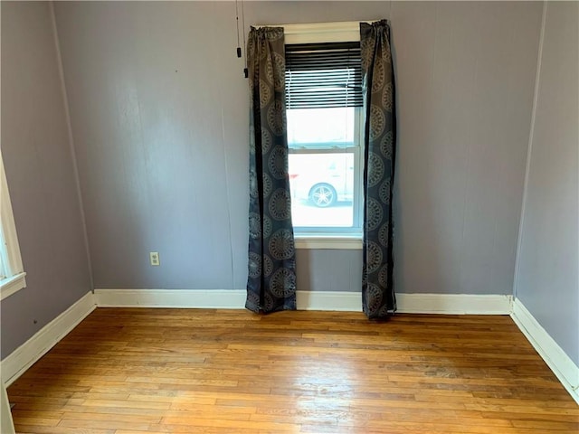 unfurnished room with light wood-type flooring