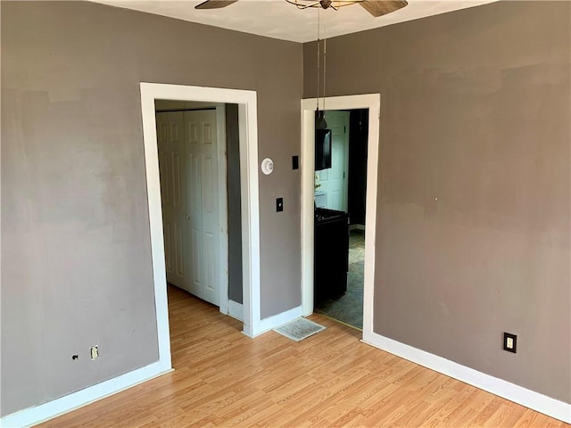 spare room featuring ceiling fan and light wood-type flooring