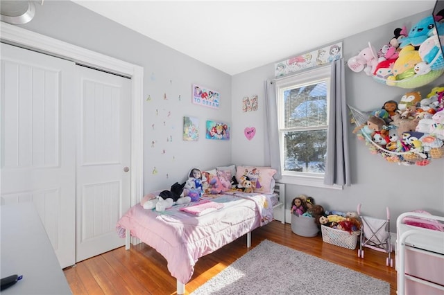 bedroom featuring hardwood / wood-style floors and a closet