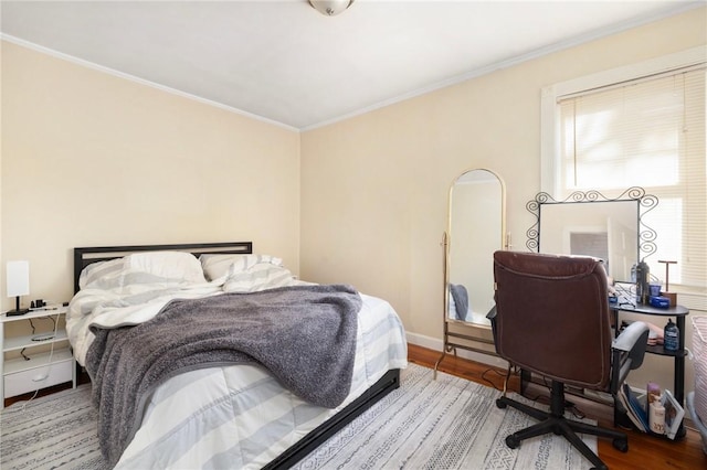 bedroom featuring wood-type flooring and crown molding