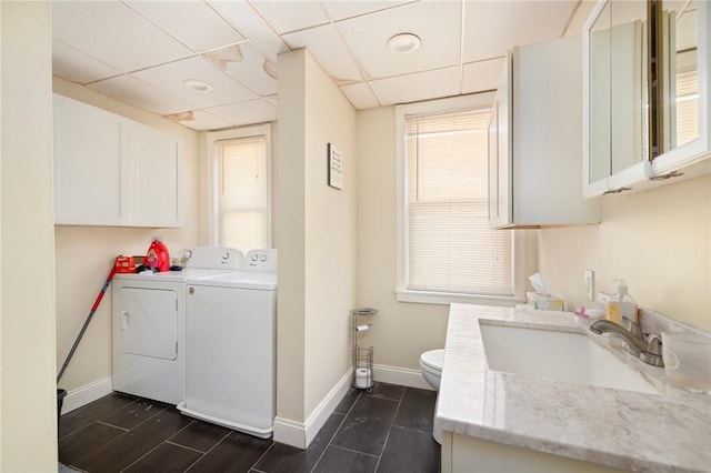 clothes washing area featuring independent washer and dryer and sink