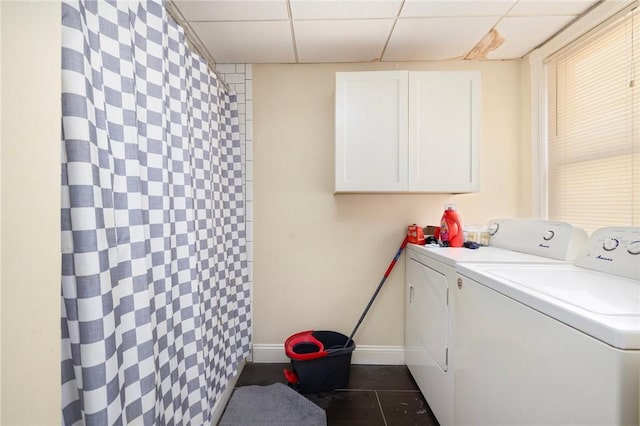 laundry area featuring separate washer and dryer and cabinets