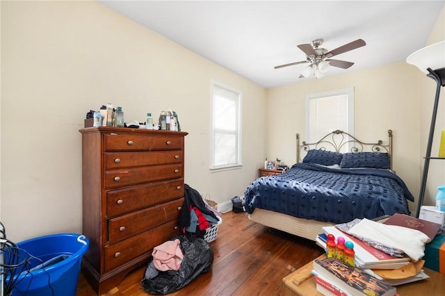 bedroom with dark wood-type flooring and ceiling fan