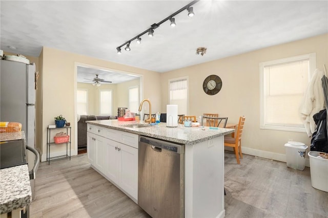 kitchen with white cabinetry, an island with sink, sink, stainless steel dishwasher, and light hardwood / wood-style flooring