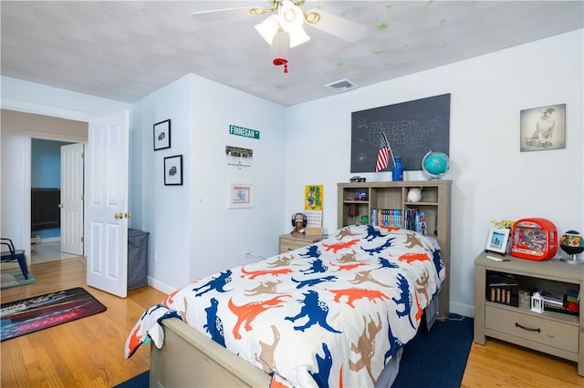 bedroom with light hardwood / wood-style floors and ceiling fan