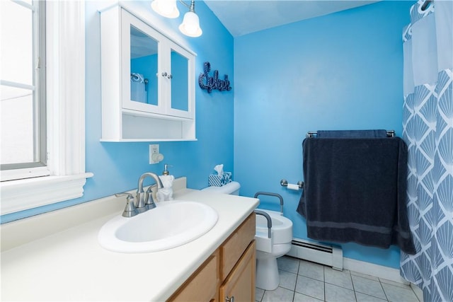 bathroom featuring vanity, tile patterned floors, baseboard heating, and toilet