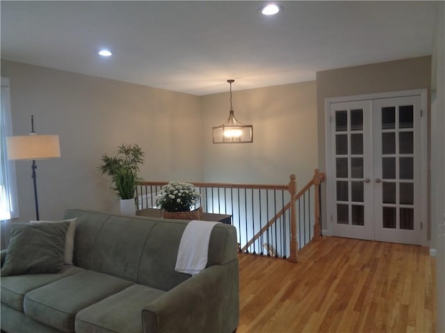 living room with french doors and light hardwood / wood-style flooring