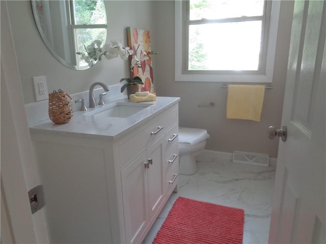 bathroom featuring vanity and toilet