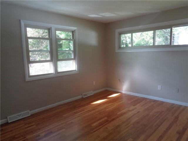 spare room with hardwood / wood-style flooring