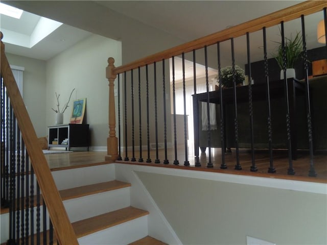 stairs with a skylight