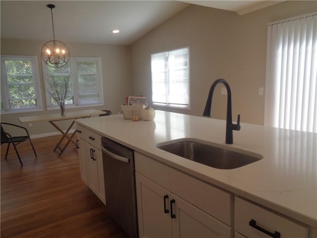 kitchen featuring dark wood-type flooring, sink, white cabinetry, decorative light fixtures, and dishwasher