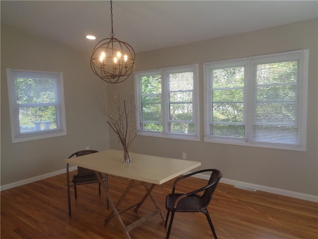 dining room featuring lofted ceiling and hardwood / wood-style floors