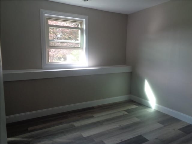 unfurnished room featuring dark hardwood / wood-style flooring