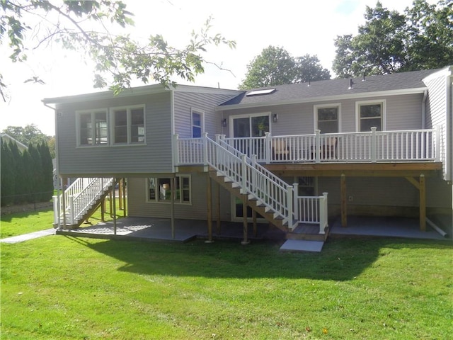 back of house featuring a patio area, a deck, and a lawn