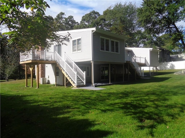 back of house featuring a yard and a deck