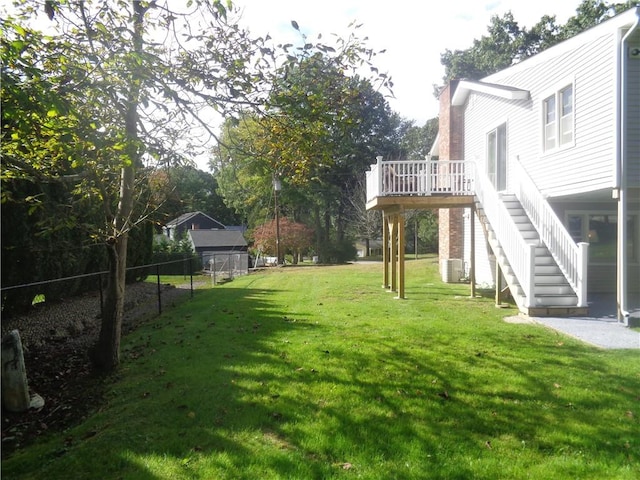 view of yard with central AC and a deck